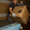 Man carrying box in Post Office at Atsugi, Japan