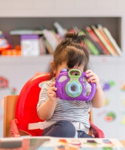 Young child holding a camera in El Paso, Texas
